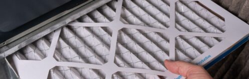 Man replacing a dirty furnace filter